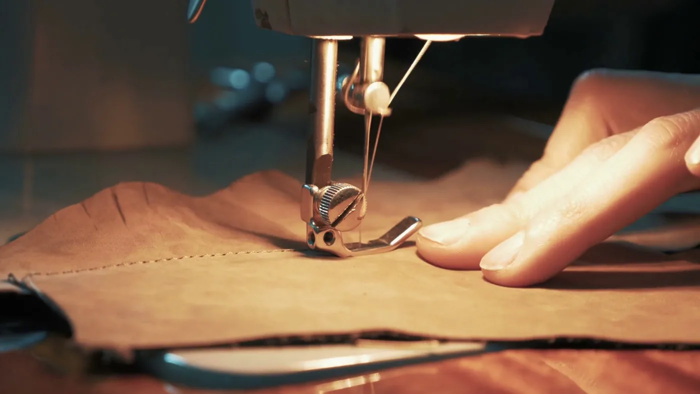 Close-up of a sewing machine stitching leather